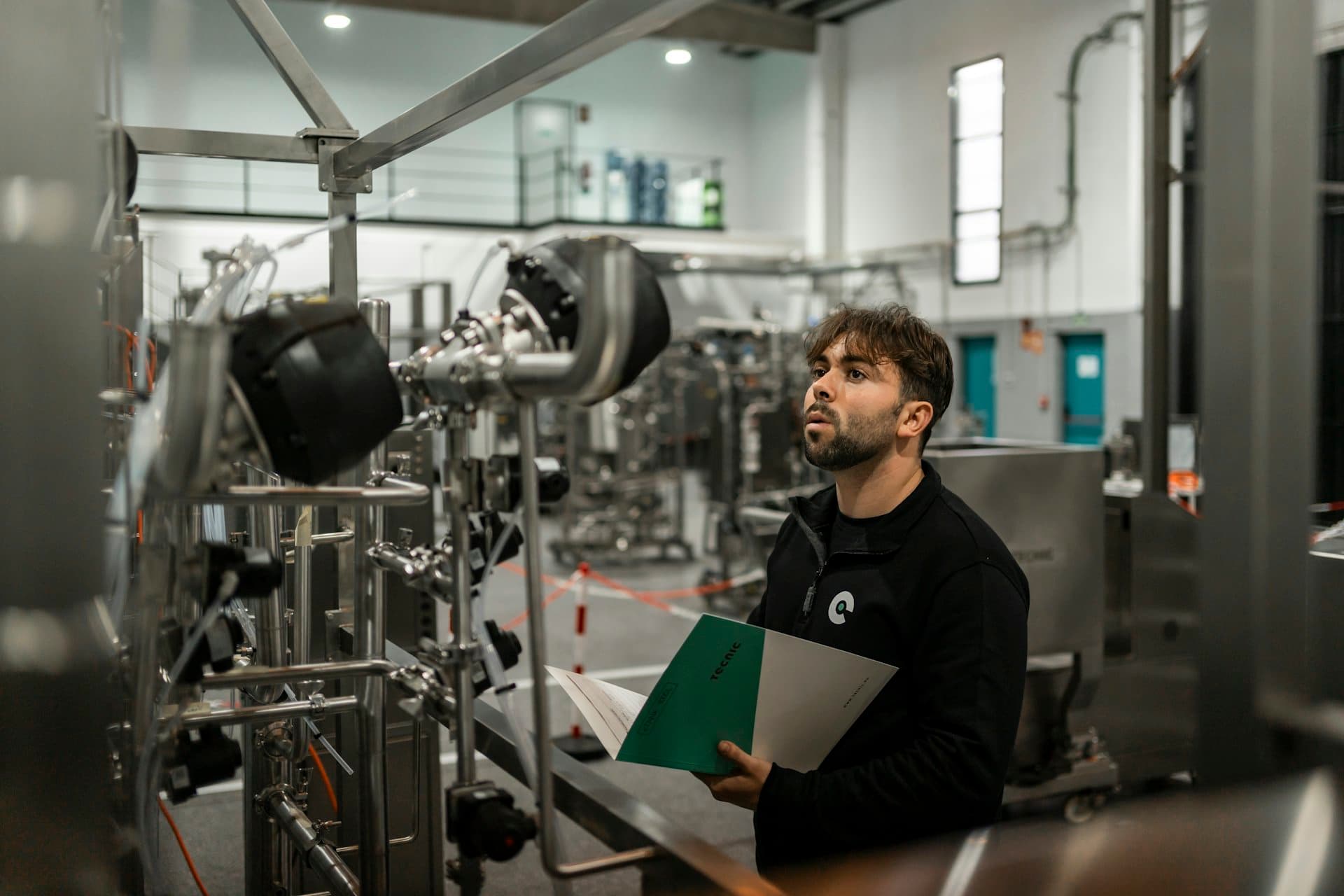 Specialist inspecting a production plant with a checklist